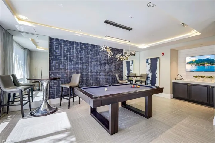 Pool/Game room with big screen TV adjoining The  Club Room for entertaining and community events