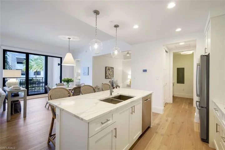 Open kitchen with access to pantry and laundry room, den and great room