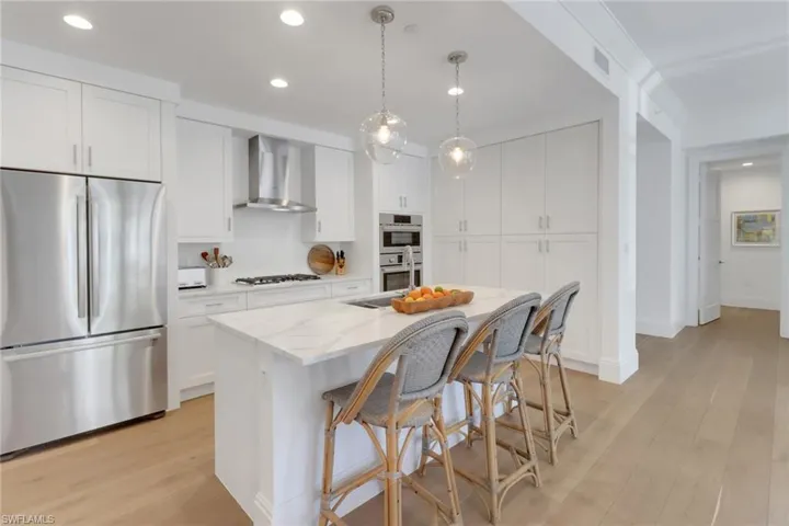 Kitchen with Bosch stainless steel appliances, Gas cooking, Quartz counters, an island with sink & tons of storage