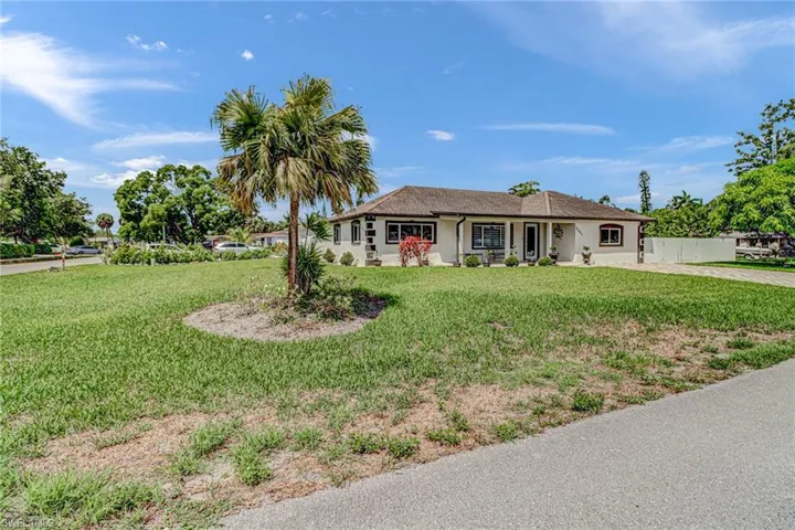 Single story home featuring a front yard on a corner lot with space to park a boat or RV on the back