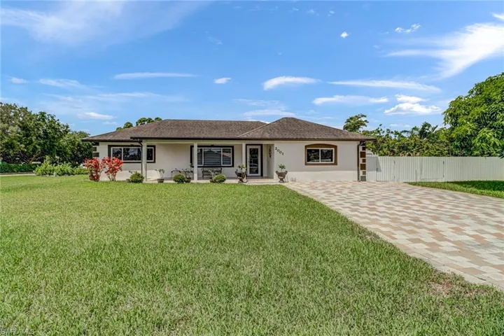 Corner lot with pavers in the driveway, fully fenced
