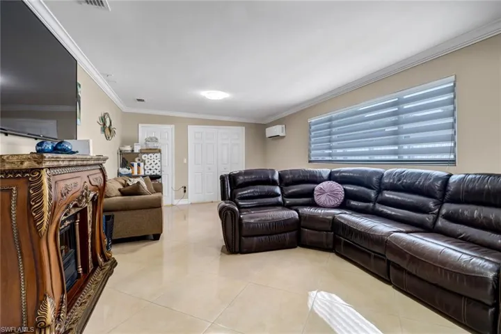 Tiled Family room with crown molding