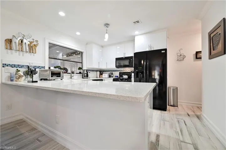 Modern kitchen featuring a large white quartz countertop island