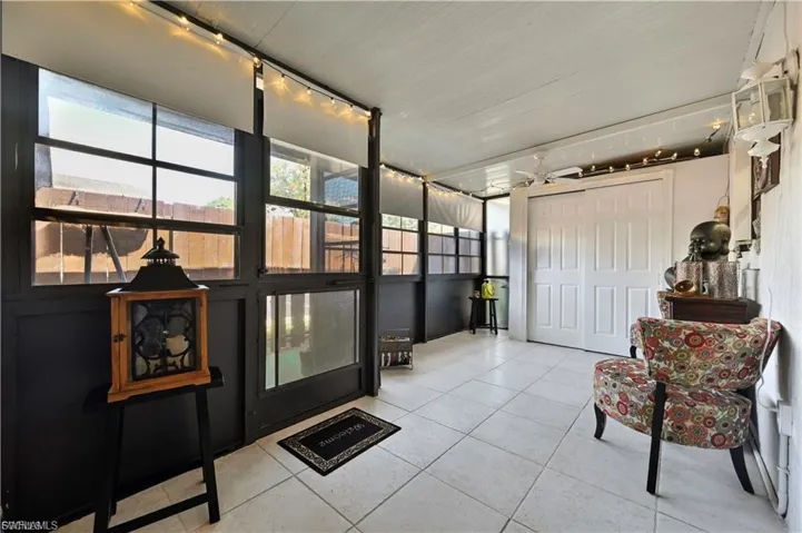 Enclosed patio featuring floor-to-ceiling windows, white tiled flooring, and a white paneled ceiling