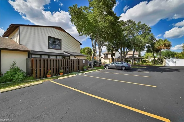Paved parking area featuring striped spaces and a concrete curb