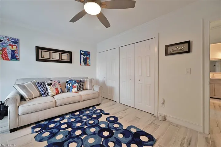 Bright room featuring wood-finish tile flooring and crown molding