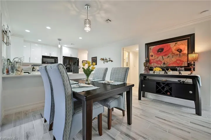 Open-concept dining area featuring wood-finish flooring