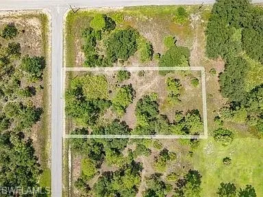Aerial view of property and surrounding area featuring property boundaries highlighted