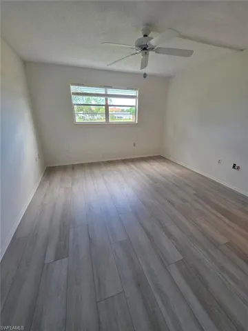 Spare room featuring a textured ceiling, light wood finished floors, and a ceiling fan