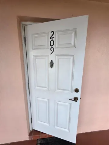 Entrance to property with stucco siding