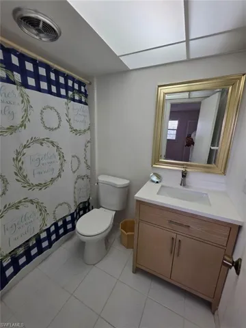 Full bathroom featuring vanity and light tile patterned floors
