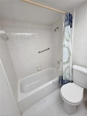 Full bathroom featuring tile patterned flooring and shower / tub combo