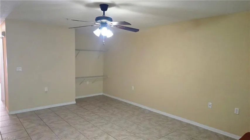 Unfurnished room featuring baseboards and ceiling fan