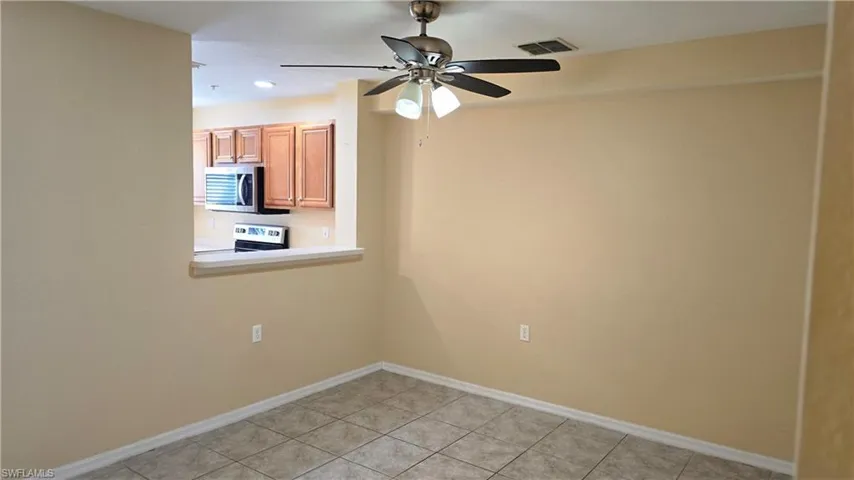 Empty room with light tile patterned flooring, ceiling fan, and recessed lighting