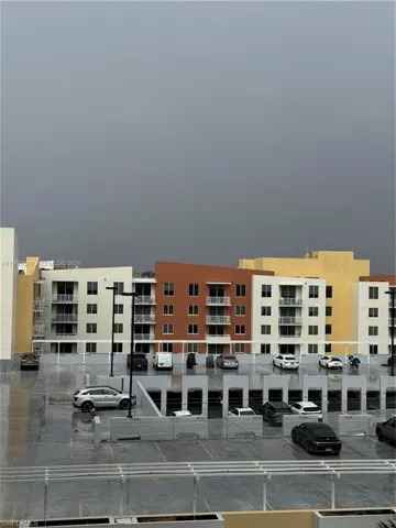 Multi-level parking garage featuring concrete construction, integrated lighting, and multiple vehicle spaces