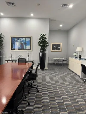 Spacious room featuring patterned carpet flooring and recessed lighting