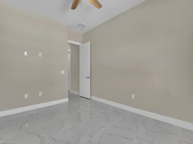 Unfurnished room featuring ceiling fan