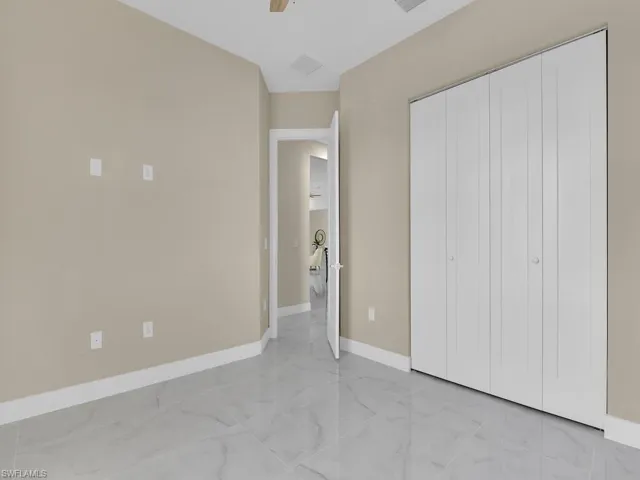 Unfurnished bedroom with a closet and ceiling fan