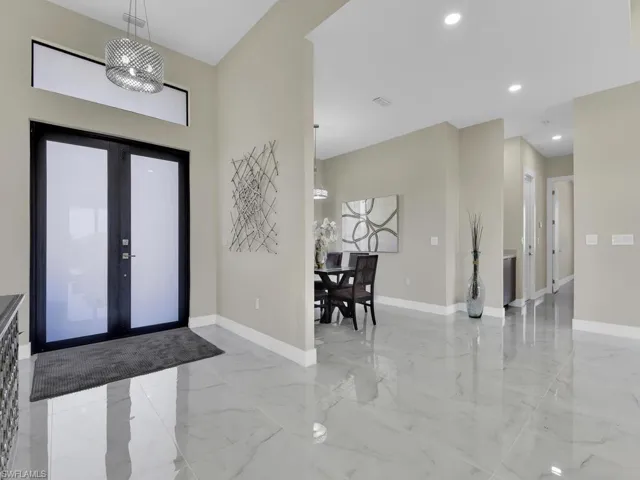 Foyer featuring french doors and an inviting chandelier