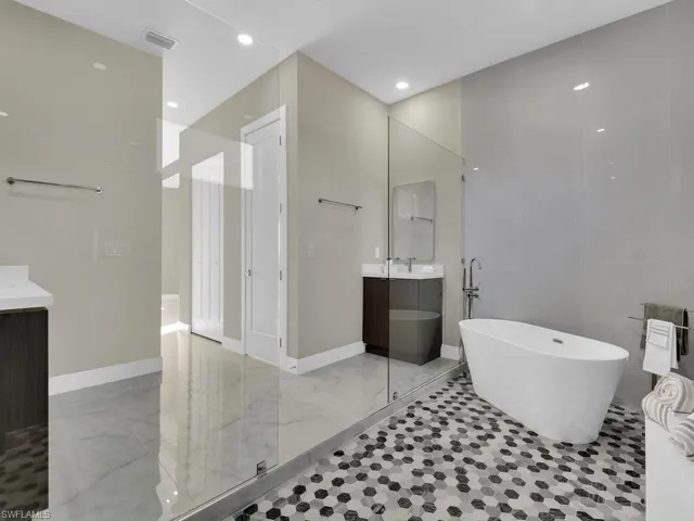 Bathroom featuring plus walk in shower and vanity