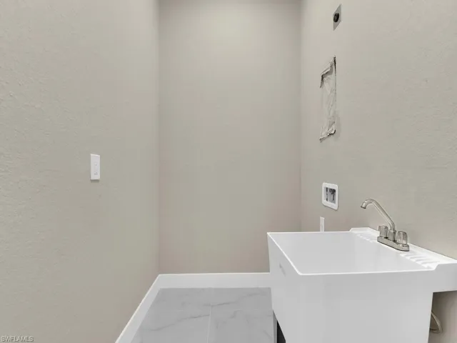 Laundry area featuring washer hookup, sink, and electric dryer hookup