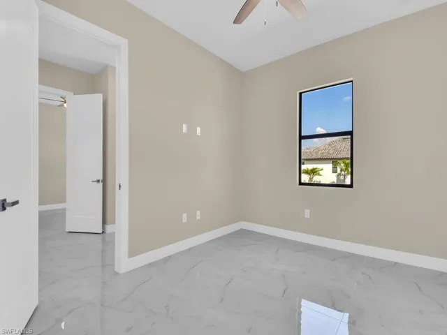 Unfurnished room featuring ceiling fan