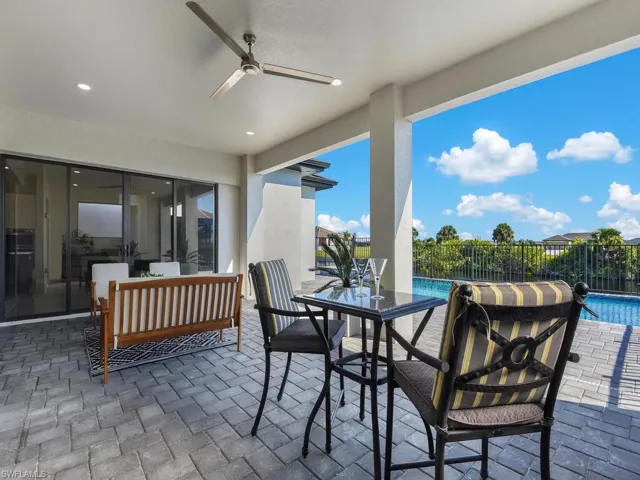 View of patio / terrace featuring ceiling fan and a fenced in pool