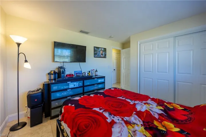 Room featuring light-toned walls, tile flooring, and white trim