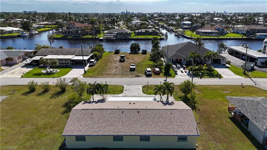 Expansive cleared lot bordered by paved roads and established residential properties