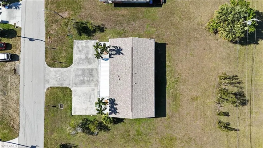 Single-story residence featuring a shingle roof and a concrete driveway