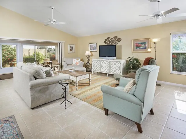 Bright and spacious living area with large windows and a cozy ambiance.