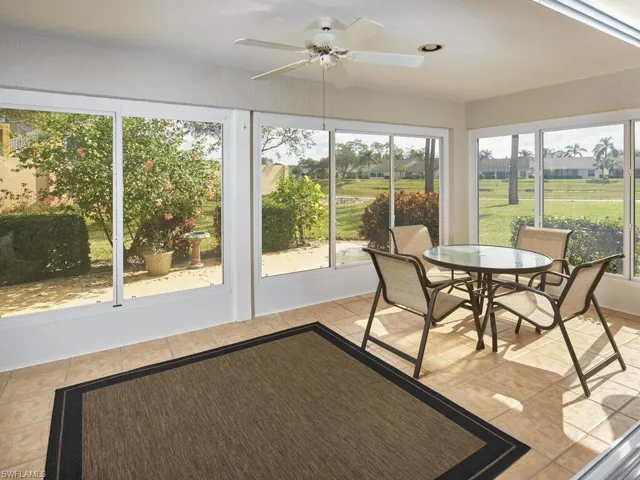 Enclosed sunroom with panoramic views and comfortable seating.