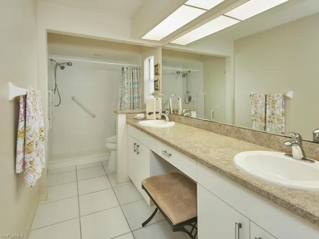 Spacious bathroom with dual sinks and a walk-in shower.
