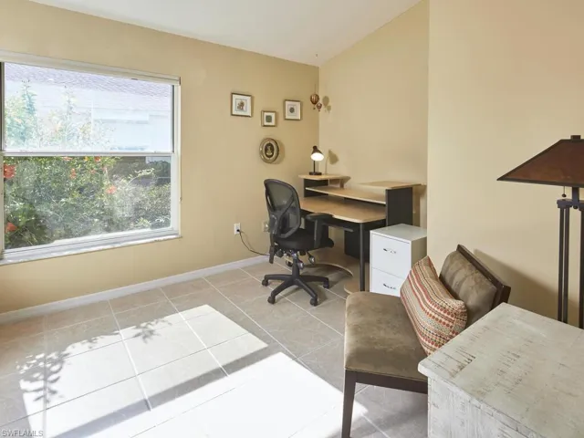Quiet and functional home office with a large window for natural light.