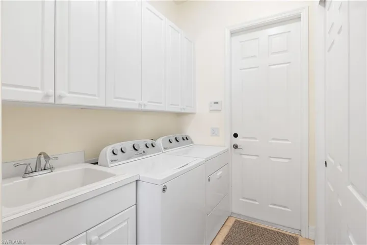 Laundry area featuring washer and dryer and cabinet space