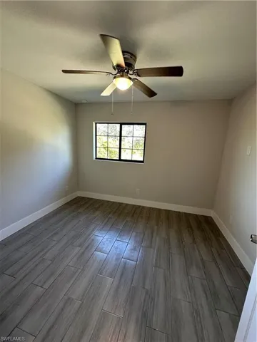 Spare room with hardwood / wood-style flooring and ceiling fan