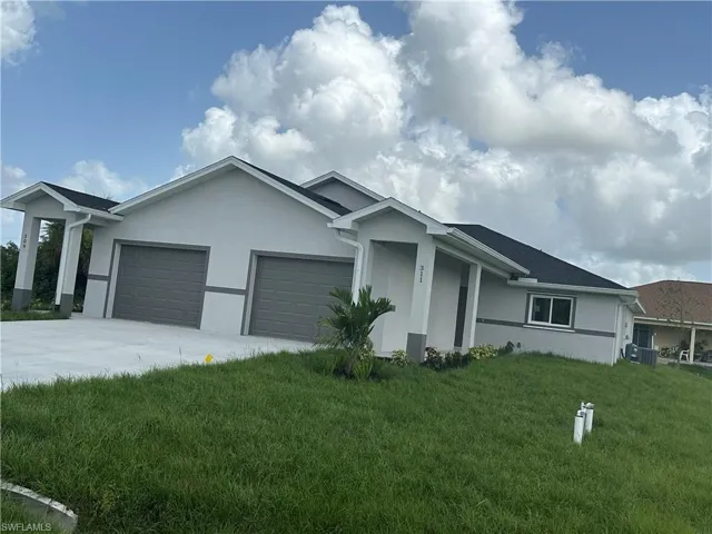 View of property exterior with a garage and a lawn