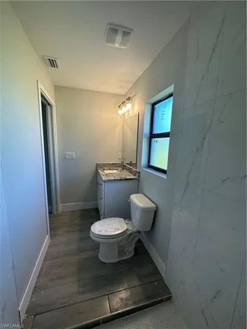 Bathroom featuring vanity and toilet