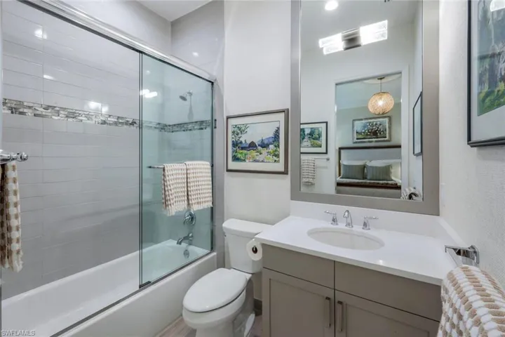 En Suite Bath is pristine with popular wood tone cabinet