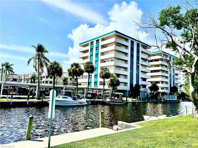 Dock area with a water view and a yard