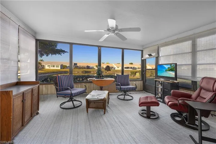 Sunroom featuring a residential view and carpet