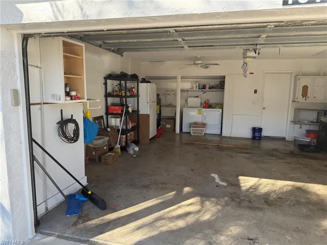 Garage featuring washer and dryer