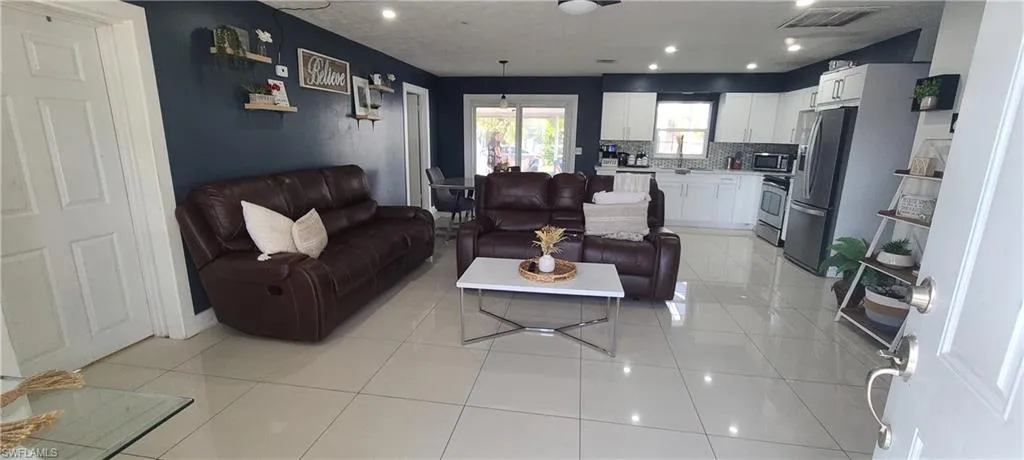 Living room featuring recessed lighting and light tile patterned flooring