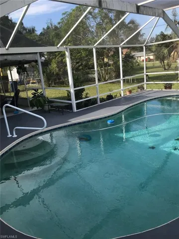 Swimming pool with a sunroom and glass enclosure