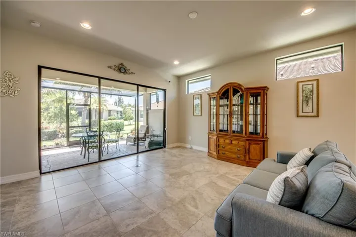 Spacious room featuring large format tile flooring, recessed lighting, and high ceilings