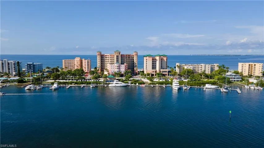 Waterfront property featuring multiple high-rise buildings and an expansive marina with numerous boat slips