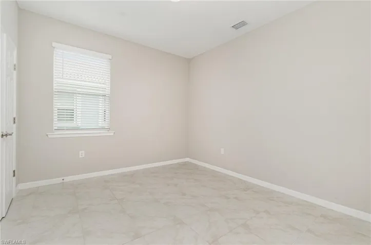 Spare room featuring baseboards