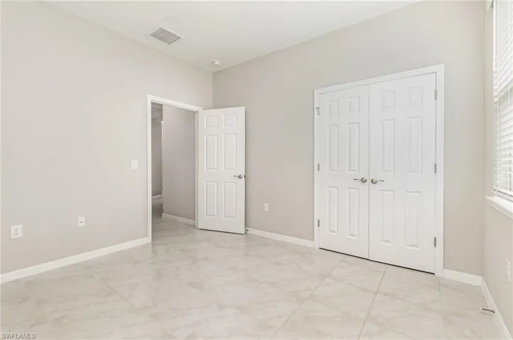 Unfurnished bedroom featuring baseboards and a closet