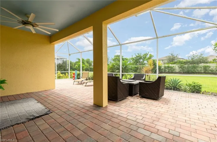 View of patio featuring a lanai, a sunroom, and ceiling fan