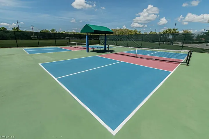 View of tennis court with community basketball court